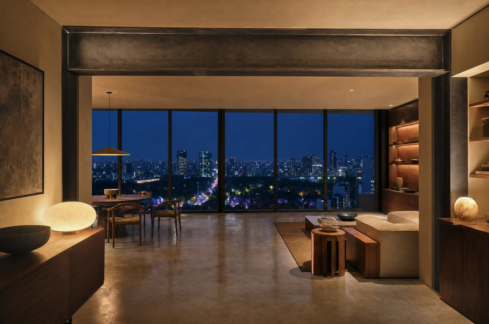 Departamento remodelado en Polanco a la hora azul: la viga estructural de acero queda a la vista sobre el muro abierto, con la ciudad iluminada al fondo