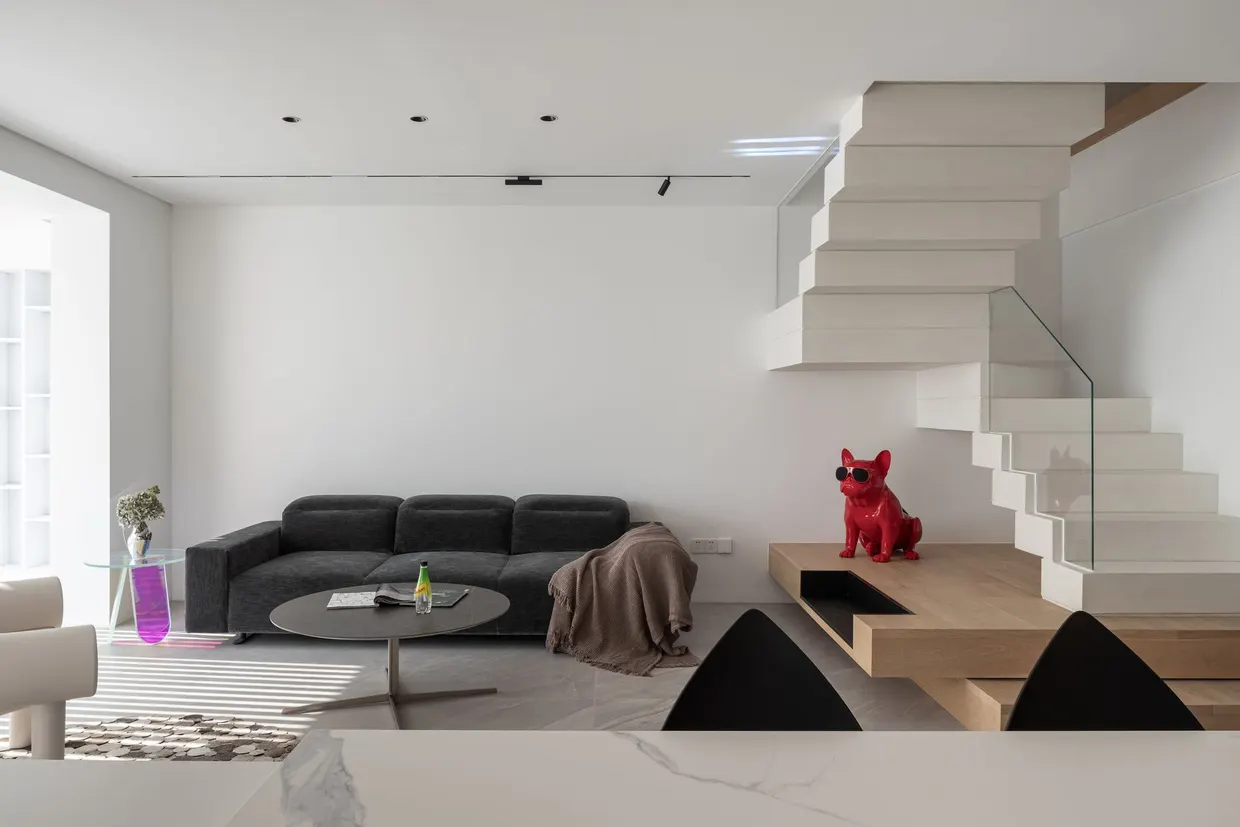 Séjour et escalier suspendu du Loft Zàntíng à Shanghai, duplex aménagé par Atelier Cantera